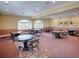 Clubhouse dining area with multiple round tables and cushioned seating at 4976 Sandpiper Dr, Oxford, FL 34484