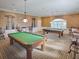 Beautiful game room offering billiards tables, pendant lighting, and comfortable seating at 4976 Sandpiper Dr, Oxford, FL 34484