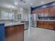 This spacious kitchen features granite countertops, stainless steel appliances, and tile flooring at 4976 Sandpiper Dr, Oxford, FL 34484