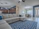 Open-concept living space with a large sectional sofa, view of the kitchen, and a dining area with natural light at 4976 Sandpiper Dr, Oxford, FL 34484