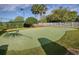 Community putting green with manicured lawn and landscaping at 4976 Sandpiper Dr, Oxford, FL 34484