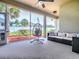 Relaxing screened-in porch featuring an egg chair, ceiling fan, and a comfortable sofa for lounging at 4976 Sandpiper Dr, Oxford, FL 34484