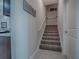 Stairway with neutral carpet and white railing at 4976 Sandpiper Dr, Oxford, FL 34484