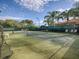 Outdoor tennis courts surrounded by lush landscaping offer a great recreational amenity at 4976 Sandpiper Dr, Oxford, FL 34484