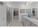 Spacious bathroom with dual sinks, granite countertops and walk-in closet at 5043 Stokes Way, Wildwood, FL 34785