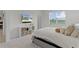 Inviting bedroom with a view, TV, and convenient storage solutions at 5043 Stokes Way, Wildwood, FL 34785