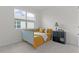 Cozy bedroom featuring a daybed with yellow bedding and natural light at 5043 Stokes Way, Wildwood, FL 34785