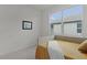Bright bedroom featuring a daybed, soft carpeting and a large window at 5043 Stokes Way, Wildwood, FL 34785