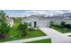 Charming single-story home showcasing a well-manicured lawn and attached two-car garage at 5043 Stokes Way, Wildwood, FL 34785