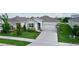 Inviting single-story home featuring a well-kept lawn, complemented by a spacious driveway at 5043 Stokes Way, Wildwood, FL 34785