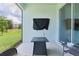 Cozy screened lanai with seating, offering a peaceful outdoor retreat overlooking the yard at 5043 Stokes Way, Wildwood, FL 34785