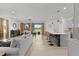 Open living space with a modern kitchen, dining area, and comfortable seating at 5043 Stokes Way, Wildwood, FL 34785