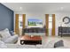 Comfortable living room featuring stylish furniture, modern decor, and bright windows at 5043 Stokes Way, Wildwood, FL 34785