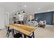 Open-concept living space with a kitchen island, gray cabinets, pendant lights, and a cozy living room area at 5043 Stokes Way, Wildwood, FL 34785