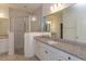 Bright bathroom features a granite-topped vanity with a glass enclosed shower and tile flooring at 5045 Balsam Falls Rd, Deland, FL 32724