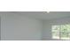 A bright bedroom featuring white walls, recessed lighting and a large window that provides ample light at 5045 Balsam Falls Rd, Deland, FL 32724