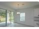 Bright dining area with tile flooring, chandelier and sliding glass doors leading to an outdoor space at 5045 Balsam Falls Rd, Deland, FL 32724