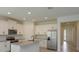 Modern kitchen with white cabinetry, stainless steel appliances, granite countertops and an island with a sink at 5045 Balsam Falls Rd, Deland, FL 32724