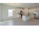 Open-concept kitchen featuring white cabinets, granite countertops, stainless appliances, island, and modern lighting at 5045 Balsam Falls Rd, Deland, FL 32724