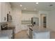Bright kitchen with white cabinets, granite countertops, stainless appliances, and an island at 5045 Balsam Falls Rd, Deland, FL 32724