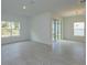 Spacious living room featuring tile floors, large windows for natural light, and sliding glass doors at 5045 Balsam Falls Rd, Deland, FL 32724