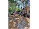 Large backyard with parking and storage sheds surrounded by mature trees at 5643 County Road 173, Wildwood, FL 34785