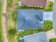 Overhead shot of the house with a lovely roof, beautiful greenery, and a stunning lake view at 5905 Caulk Ct, The Villages, FL 32163
