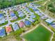 Stunning aerial view of a home in a vibrant community with a serene lake at 5905 Caulk Ct, The Villages, FL 32163