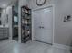 Bathroom features a modern glass shower, shelving unit and gray cabinets at 5905 Caulk Ct, The Villages, FL 32163