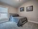 Bedroom with a large bed, neutral walls and carpet at 5905 Caulk Ct, The Villages, FL 32163