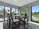 Sunroom dining area with scenic water views, ideal for elegant meals and relaxation at 5905 Caulk Ct, The Villages, FL 32163