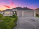 Charming single-story home featuring a 3-car garage, lovely landscaping and modern design elements at 5905 Caulk Ct, The Villages, FL 32163