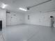 Clean, spacious garage with epoxy flooring, offering ample storage and room for organization at 5905 Caulk Ct, The Villages, FL 32163