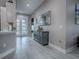 Beautiful hallway with stylish gray floors and a decorative mirror at 5905 Caulk Ct, The Villages, FL 32163