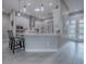 Modern kitchen featuring gray cabinets, pendant lighting, and a spacious breakfast bar at 5905 Caulk Ct, The Villages, FL 32163