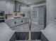 Modern kitchen with gray cabinets and open shelving at 5905 Caulk Ct, The Villages, FL 32163