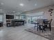 Open floor plan featuring a comfortable living room and dining area with lake views at 5905 Caulk Ct, The Villages, FL 32163