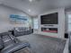 Living room featuring a large fireplace, TV and comfortable sofas, perfect for relaxation at 5905 Caulk Ct, The Villages, FL 32163