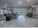Bright living room featuring an open floor plan with light-colored floors and water views at 5905 Caulk Ct, The Villages, FL 32163