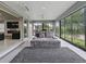 Sunroom includes plush seating and large windows with scenic views, open to the main living space at 5905 Caulk Ct, The Villages, FL 32163