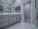 Modern bathroom with a grey vanity, pendant lighting, and open doorway to water closet at 5905 Caulk Ct, The Villages, FL 32163