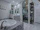 Bright and airy main bathroom with modern finishes and a soaking tub and glass enclosed shower at 5905 Caulk Ct, The Villages, FL 32163
