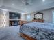 Relaxing main bedroom with a fireplace and an entertainment center with a large-screen television at 5905 Caulk Ct, The Villages, FL 32163