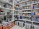 Spacious pantry with ample shelving, storage bins, and organized food items for convenient access at 5905 Caulk Ct, The Villages, FL 32163