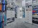 Walk-in closet with shelving, drawers, shoe racks, and grey carpeting at 5905 Caulk Ct, The Villages, FL 32163