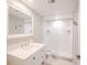 Bright bathroom with white tiled shower, modern vanity with sink, and a clean, fresh design at 601 W Old Hwy 441 # 11B, Mount Dora, FL 32757