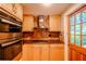 Well-equipped kitchen with stainless steel appliances, ample cabinetry, and stone backsplash at 601 W Old Hwy 441 # 11B, Mount Dora, FL 32757