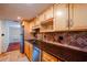 Kitchen featuring wooden cabinets, stainless steel appliances, and granite counters at 601 W Old Hwy 441 # 11B, Mount Dora, FL 32757