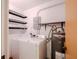 Functional laundry room with shelving, washer, dryer, and a modern water heater at 601 W Old Hwy 441 # 11B, Mount Dora, FL 32757