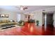 Bright living room with red wood floors, neutral paint, stylish furniture, and an open layout at 601 W Old Hwy 441 # 11B, Mount Dora, FL 32757